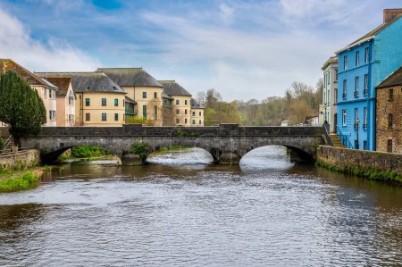 Photo for A view of the road bridge over the River Cleddau in the centre of Haverfordwest, Pembrokeshire, Wales on a spring day - Royalty Free Image