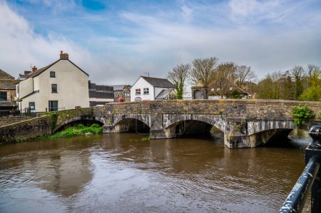 Photo for A view across the old bridge over the River Cleddau in the centre of Haverfordwest, Pembrokeshire, Wales on a spring day - Royalty Free Image