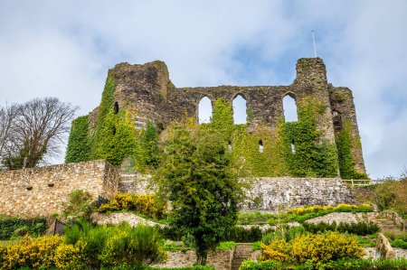 A view looking up at the castle ruins above the River Cleddau in Haverfordwest, Pembrokeshire, Wales on a spring day