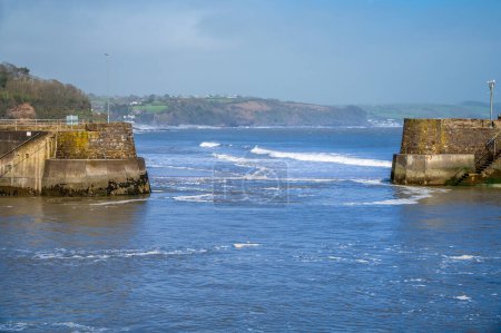 A view out to sea through the harbour entrance in Saundersfoot, Wales on a bright spring day