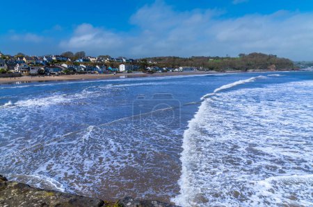 A view from the harbour of the tide turning in the village of Saundersfoot, Wales on a bright spring day