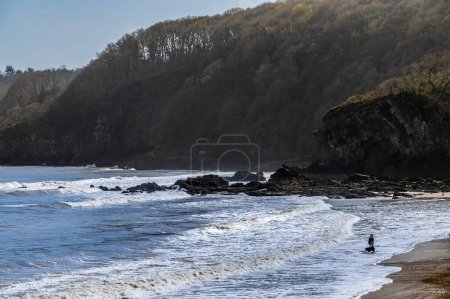A view from the harbour towards the back beach in the village of Saundersfoot, Wales on a bright spring day