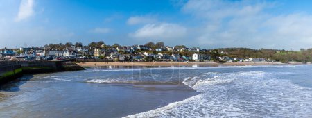 A view from the harbour towards the beach in the village of Saundersfoot, Wales on a bright spring day