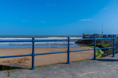 A view out to sea from the beach in the village of Saundersfoot, Wales on a bright spring day