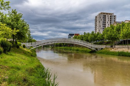 A view along the River Drin towards a pedestrian bridge at Lezhe, Albania in summertime