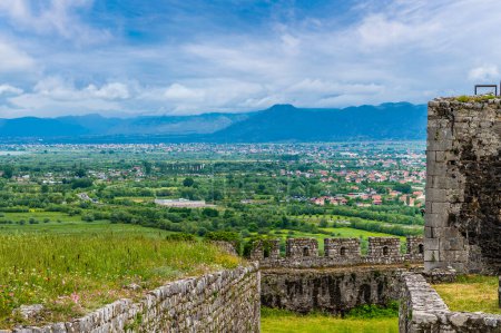A view past the ramparts of Rozafa castle towards the city of Shkoder in Albania in summertime