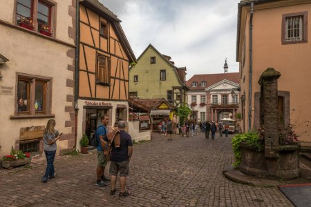 Photo for RIQUEWIHR, FRANCE-AUGUST 15, 2022: Pedestrian street in the historic center of the Alsatian commune of Riquewihr - Royalty Free Image