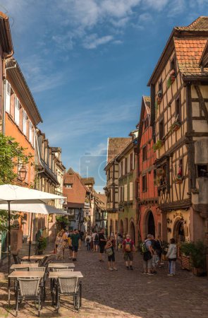 Photo for RIQUEWIHR, FRANCE-AUGUST 15, 2022: Pedestrian street in the historic center of the Alsatian commune of Riquewihr - Royalty Free Image