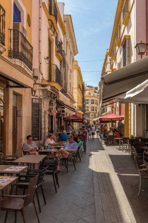 Photo for SEVILLE, SPAIN-MAY, 17, 2022: small street in the old town of Seville, Andalusia, Spain - Royalty Free Image