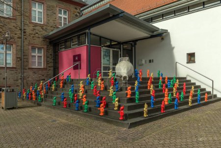 Photo for Colorful garden gnomes stand on a staircase in front of the Citymuseum Hofheim am Taunus - Royalty Free Image