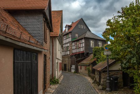 Foto de KRONBERG, ALEMANIA-OCTUBRE 07, 2021: pequeña calle con casas de entramado de madera en el casco antiguo histórico, Kronberg im Taunus, Alemania - Imagen libre de derechos