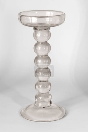 A tall glass candle holder isolated on a white background