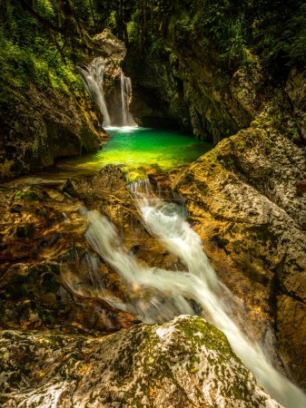 Photo for Green pool and waterfall of river Lepenca in Sunik water grove, Lepena valley, Bovec, Slovenia, water background, turquoise, mountain river, stream, Soca valley, Triglav national park, Europe. - Royalty Free Image