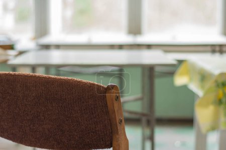 Photo for Chairs, a window and a table in an abandoned and dilapidated holiday house in the style of the People's Republic of Poland. - Royalty Free Image