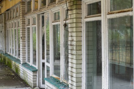 Foto de Una interesante vista de viejas ventanas en un edificio olvidado en el estilo de los años 80, urbex. - Imagen libre de derechos