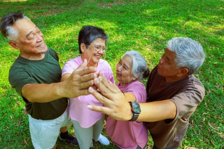 Top view group asian elderly retired people who are in good health join hands together join forces recreational activities play sports exercise have fun in the morning have good mood live long life.