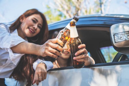 Téléchargez les photos : Images floues et douces, 2 femmes asiatiques conduisant dans un état d'ivresse à la suite de la consommation d'alcool, concept de boire de l'alcool pendant la conduite, il est la cause d'accidents sur la route. - en image libre de droit