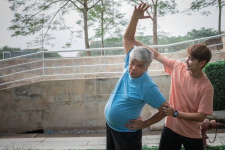 Téléchargez les photos : Asian family, Son helping elderly father which is obese in the belly to exercise starting from stretching the arm muscles. to elderly health care and exercise concept. - en image libre de droit