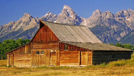 Photo for Wooden barn with mountains behind - Royalty Free Image