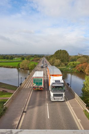 Photo for Heavy goods vehicle crossing a river bridge - Royalty Free Image