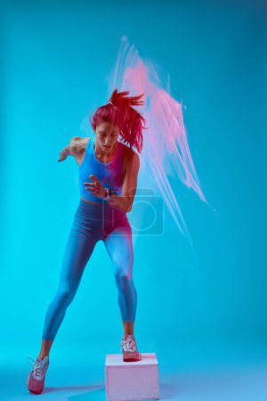 Photo for A sportswoman doing box jumps and exercising. Long exposure movement. - Royalty Free Image