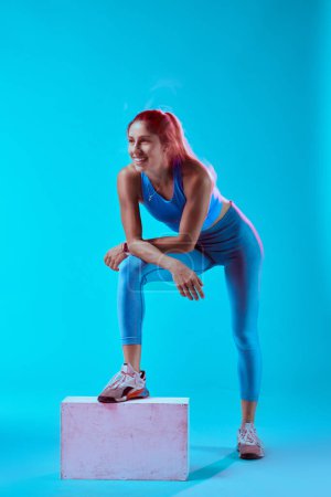 Photo for A sportswoman doing box jumps and exercising. Long exposure movement. - Royalty Free Image