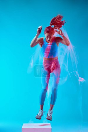 Photo for A sportswoman doing box jumps and exercising. Long exposure capture movement. - Royalty Free Image