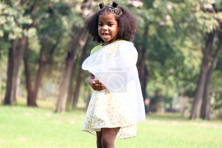 Photo for Happy smiling African Girl with black curly hair holding sweep nets to catch flying insects outdoor green park garden, beautiful kid playing outside on sunny day, cute child play in summer. - Royalty Free Image