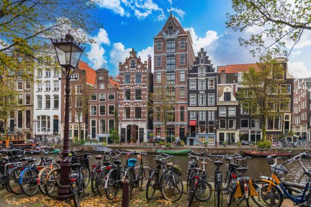 Photo for Typical Dutch facade along the canals, with many bicycles, in Amsterdam, Holland, Netherlands - Royalty Free Image