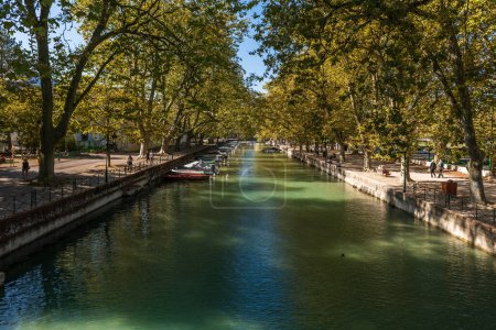 Photo for Quai Jules Philippe, a canal in the shade of plane trees, on Lake Annecy, in Haute Savoie, France - Royalty Free Image