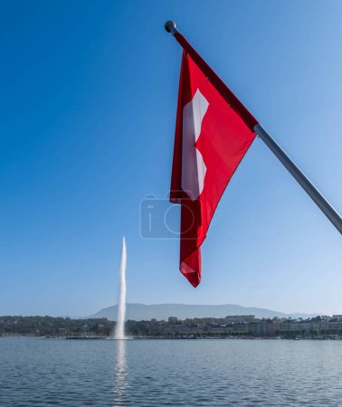 Photo for Geneva's iconic water jet and the Swiss flag, in Geneva, Switzerland - Royalty Free Image