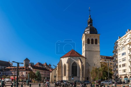 Photo for Rear of the Saint Maurice church and its bell tower, and a residence, in Annecy, Haute Savoie, France - Royalty Free Image