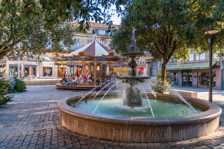 Photo for Fountain and carousel on Civoire square, in Brive la Gaillarde, in Correze, Nouvelle-Aquitaine, France - Royalty Free Image