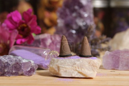 Photo for Amethyst Crystals With Flowers and Incense Cones on Meditation Altar - Royalty Free Image