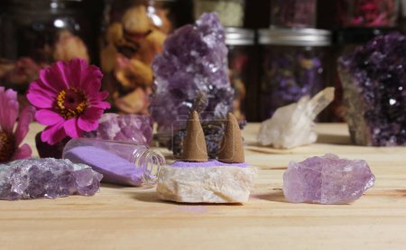Photo for Amethyst Crystals With Flowers and Incense Cones on Meditation Altar - Royalty Free Image