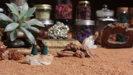 Foto de Aragonite Crystal With Incense Cones on Australian Red Sand - Imagen libre de derechos