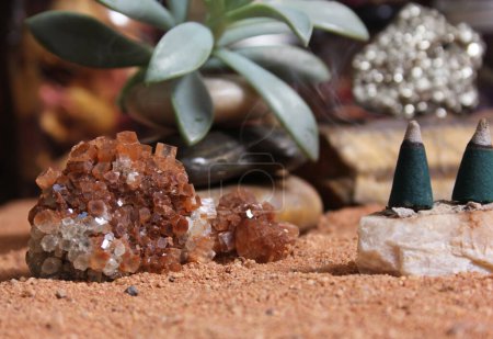 Foto de Aragonite Crystal With Incense Cones on Australian Red Sand - Imagen libre de derechos