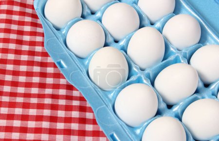 Photo for Carton of Eggs on Rustic Table With Red Checkered Table Cloth - Royalty Free Image
