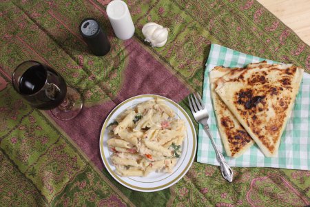 Photo for Plate of Pasta Carbonara With Italian Flat Bread on Rustic Kitchen Table - Royalty Free Image
