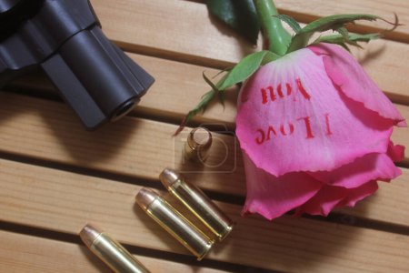 Vintage Gun With Bullets and Rose. Revolver and Ammo