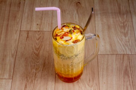 Photo for Chill mango Falooda in glass on wooden background - Royalty Free Image