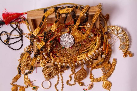 Téléchargez les photos : Bijoux en or EN bois Durga, Saraswati ou laxmi pièce d'argent isolé sur fond blanc. dieu indien. - en image libre de droit