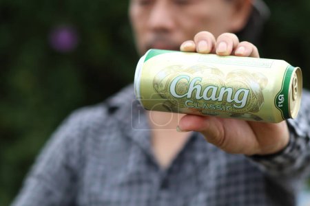 Photo for Chiang Mai Thai 11 August 2021 In hand of a young man holding a can of Chang beer outstretched to reveal the golden Chang beer logo prominently because Chang is a very popular beer in Thailand - Royalty Free Image