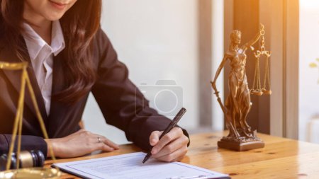 Photo for Lawyer holding contract documents in hand and preparing to sign a consulting contract for a team of business people who need legal advice to run their business in accordance with the law - Royalty Free Image