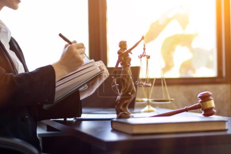 A team of lawyers is consulting and examining legal matters from law books to assist clients who come to consult legal issues regarding litigation. concept of a legal advisory team