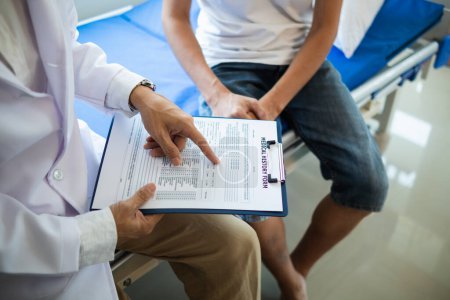 Photo for Doctor is having consultation discussing prostate cancer and venereal cancer detected in young man. Current doctors provide advice and counseling on detecting prostate cancer and treating it properly. - Royalty Free Image