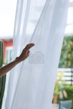 Photo for Woman wearing see through nightgown stands alone lonely and depressed due to her depression and having to take medication to reduce stress when alone. woman who is depressed because of being alone - Royalty Free Image