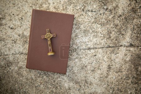 Photo for Cross represents God placed on Bible which is teaching of God according to Christian faith. cross and Bible were placed on table in room as they were prepared for prayers to God by faith. - Royalty Free Image