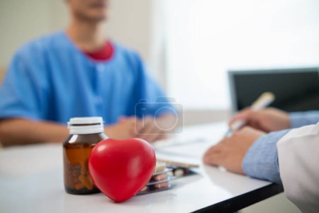 Photo for A heart patient visits a doctor for advice on health care and medication to treat heart disease symptoms after the medical team has diagnosed and examined the patient for heart abnormalities. - Royalty Free Image