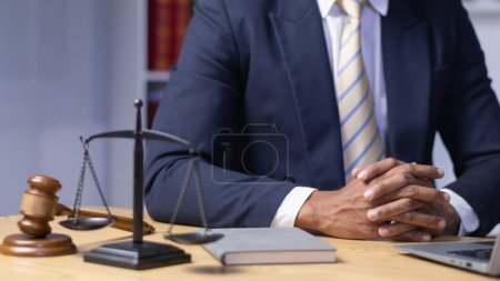 Photo for Lawyer used his hands together as sign to pray to God based on his faith and power of faith in God and to pray that he would be able to win case based on the evidence and information gathered. - Royalty Free Image